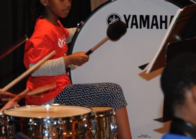 Young girl playing drum