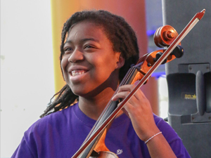 A teenage OrKidstra student with a cello