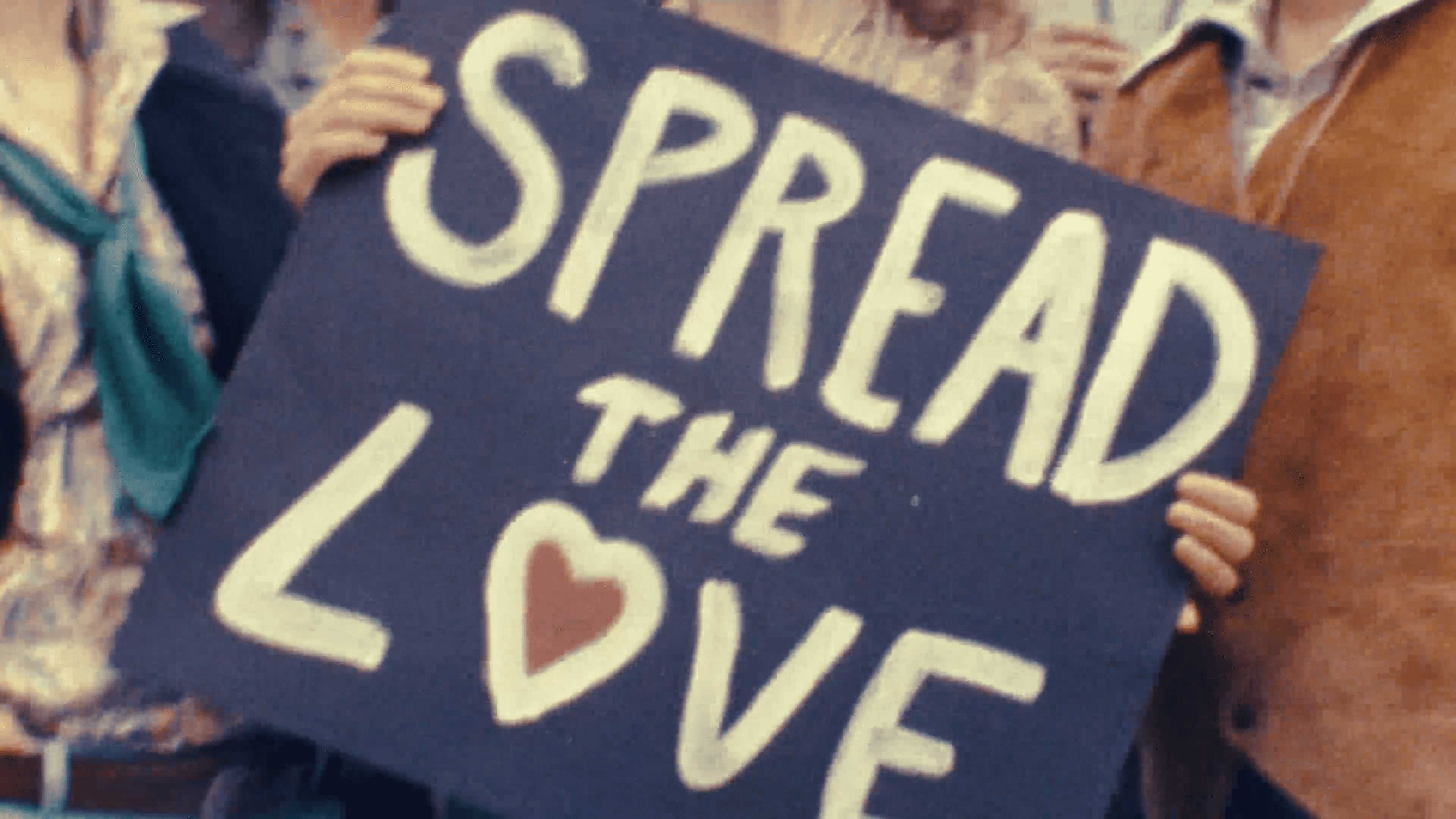 A photo of a sign that says "Spread The Love"
